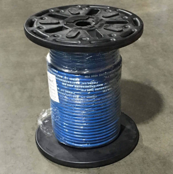 Blue solution cleaner hose on a black reel in the warehouse.